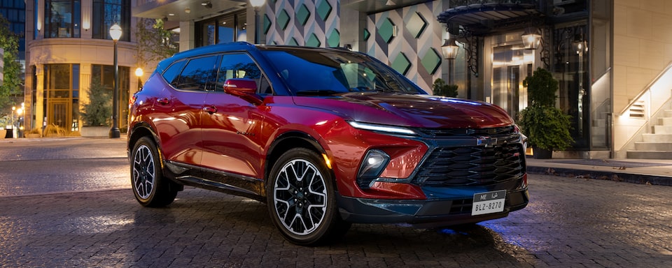 The 2024 Radiant Red Tintcoat Chevy Blazer Parked at Night in the City