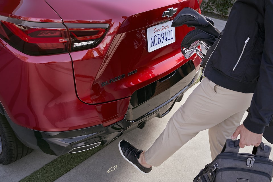 Person Using Automatic Lift Tailgate Feature by Putting Their Leg Near the Rear of the Vehicle