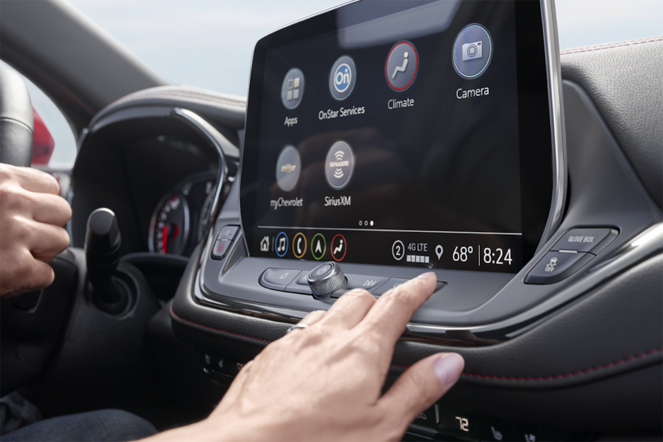 A Person Reaching For the Infotainment System in the 2024 Chevrolet Blazer SUV