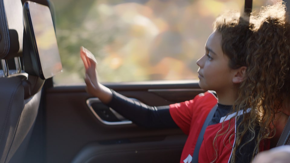 Two Children Enjoy the Spacious Cabin of the MY24 Chevy Suburban