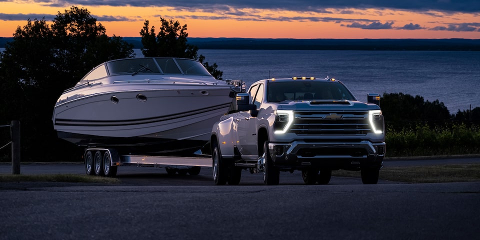 The 2024 Summit White Silverado HD Leaving the Lake while Hauling a Boat