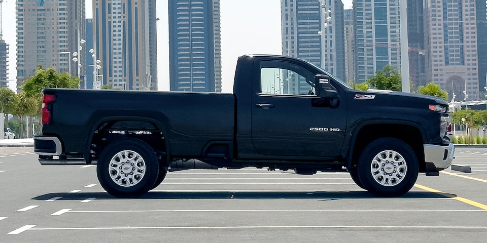 The 2024 Black Silverado HD Displayed Outside of A Modern Ranch Home